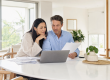 Couple reviewing home loan refinancing documents together at a bright modern Australian home